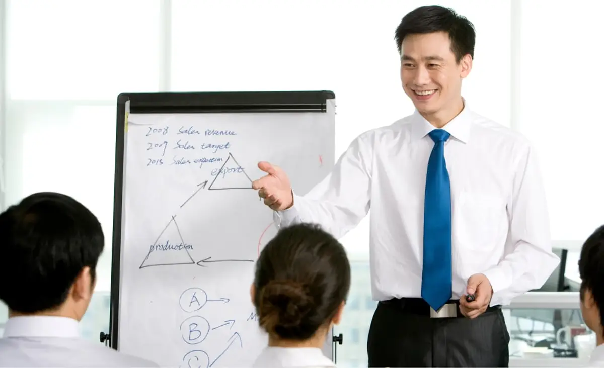 Man presenting sales targets to team
