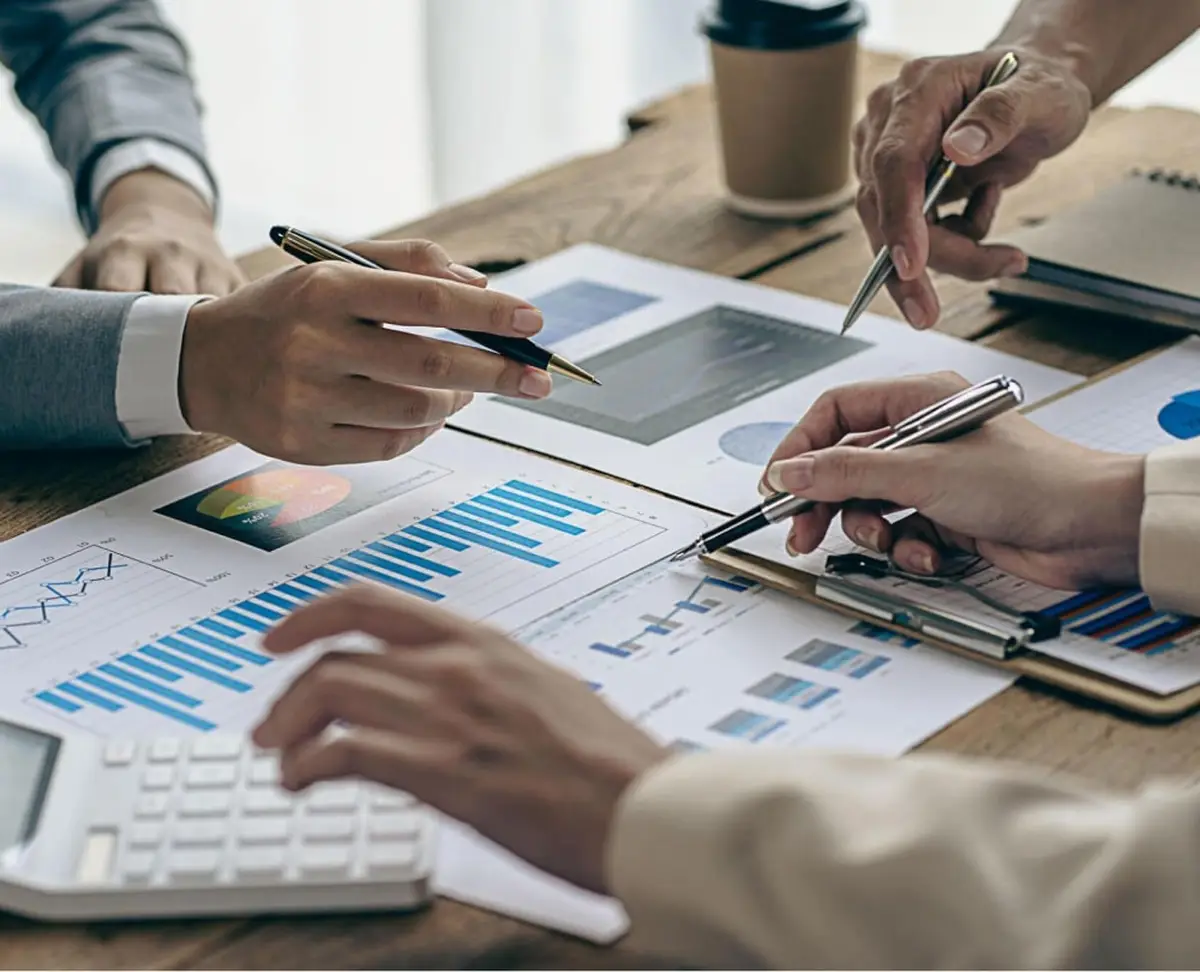 Business team analyzing financial charts and graphs